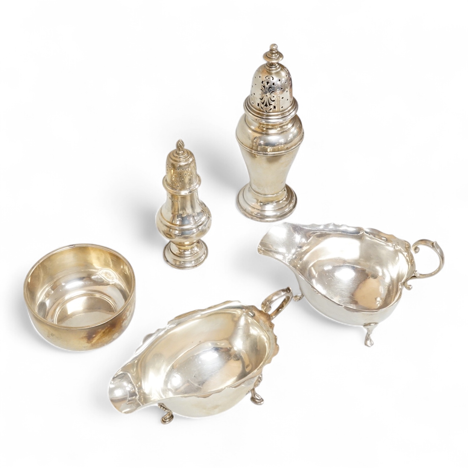 Two George V silver sauceboats, one by Asprey & Co, a silver pepperette, a silver bowl and a modern silver sugar caster, 16oz.